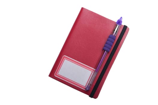 red notebook diary or agenda and purple pen lying on the top (isolated on white background)