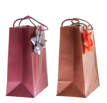 two colorful gift paper bags with bows isolated on white background