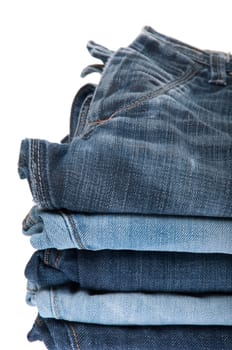 stack of blue jeans isolated on white background