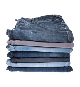 stack of various jeans isolated on white background