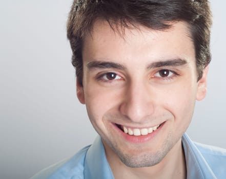 portrait of a smiling handsome trainee starting business career (close-up)