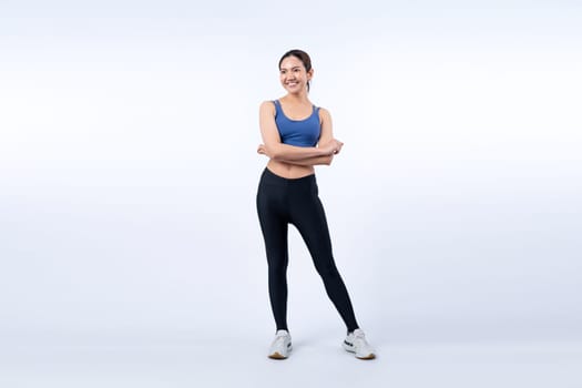 Full body asian woman in sportswear portrait, smiling and posing cheerful gesture. Workout training with attractive girl engage in her pursuit of healthy lifestyle. Isolated background Vigorous