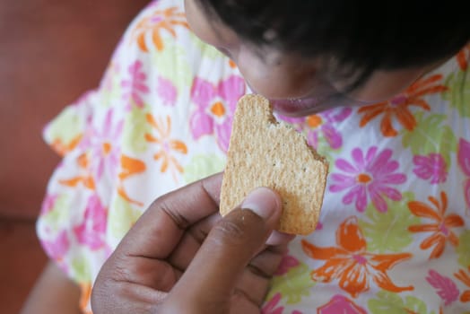 child eating sweet cookies closeup.