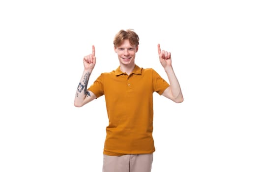 young charming red-haired man dressed in a yellow T-shirt wants to tell the news.