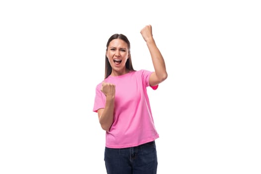 young charismatic good-looking woman with black hair wearing a pink t-shirt is experiencing joy and pleasure.