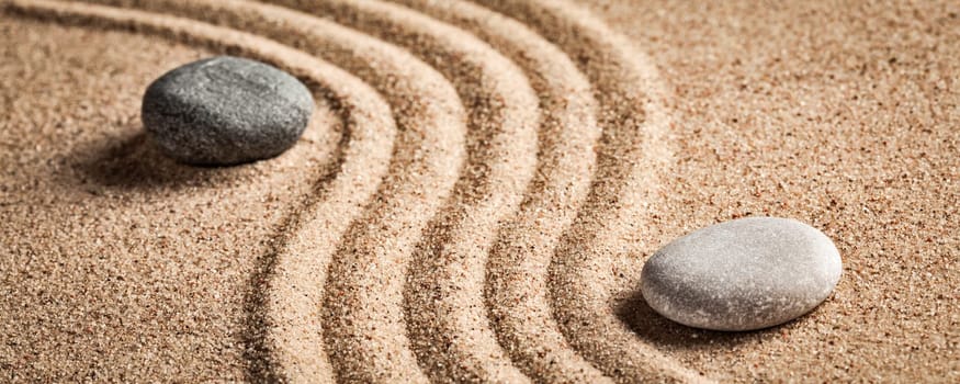Japanese Zen stone garden - relaxation, meditation, simplicity and balance concept - letterbox panorama of pebbles and raked sand tranquil calm scene