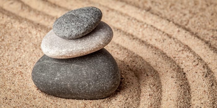 Japanese Zen stone garden - relaxation, meditation, simplicity and balance concept - letterbox panorama of pebbles and raked sand tranquil calm scene