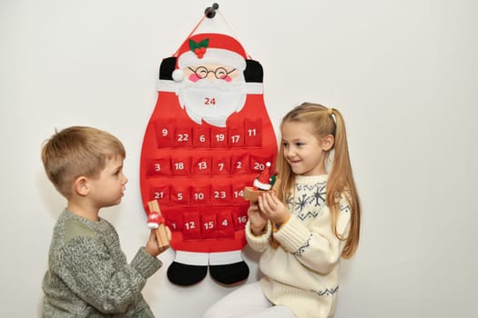 The brother and sister found gifts in Felt santa claus advent calendar