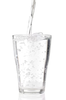 fresh water pouring into a glass isolated on white background