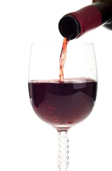 bottle pouring red wine into a crystal glass (isolated on white background)
