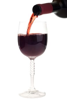 bottle pouring red wine into a crystal glass (isolated on white background)