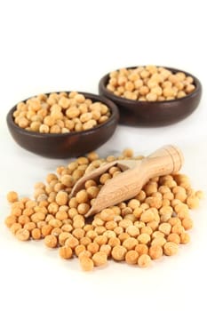 yellow peas and a shovel against white background