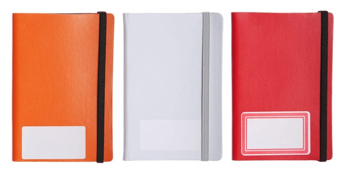 collection of three colorful notebooks, diary or agenda (isolated on white background)