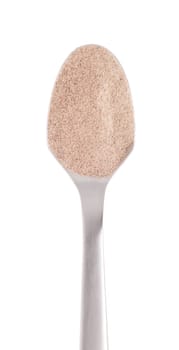 white pepper spice on a stainless steel spoon, isolated on white background