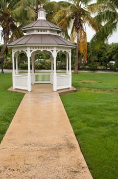 pathway to grgeous white gazebo after a tropical storm (outdoor setting)