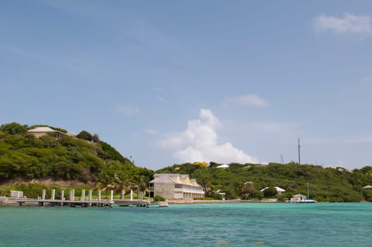 Antigua Long Bay, gorgeous seascape view surrounded by tropical nature and some typical houses