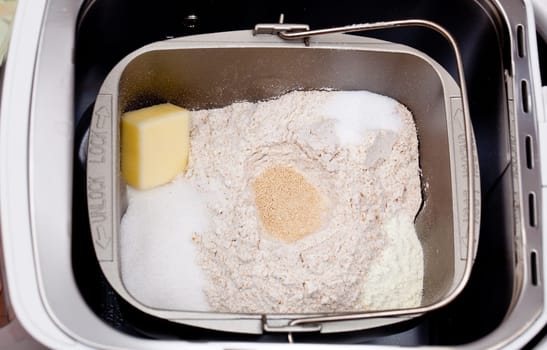 Bread making machine with ingredients prepared for mixing