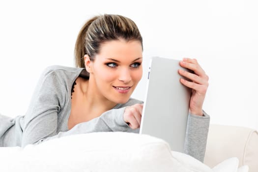 young woman on sofa with tablet at home