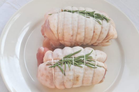 Chicken rolls with rosemary in a dish
