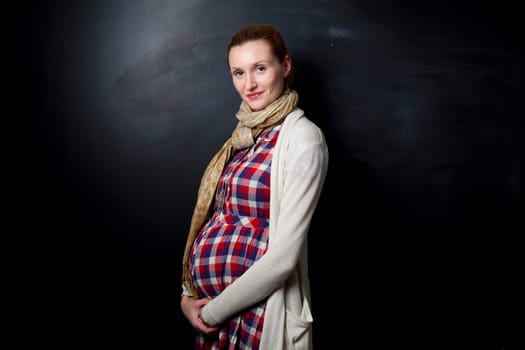 Portrait of a beautiful pregnant mother. Studio shot.