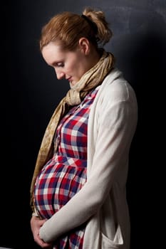 Portrait of a beautiful pregnant mother. Studio shot.