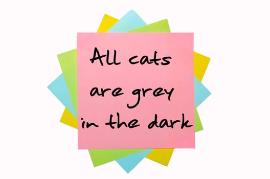 text "All cats are grey in the dark"" written by hand font on bunch of colored sticky notes"
