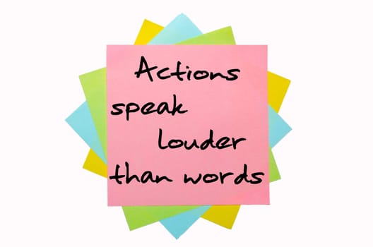 text "Actions speak louder than words"" written by hand font on bunch of colored sticky notes"