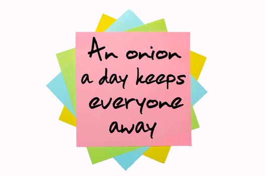 text "An onion a day keeps everyone away"" written by hand font on bunch of colored sticky notes"