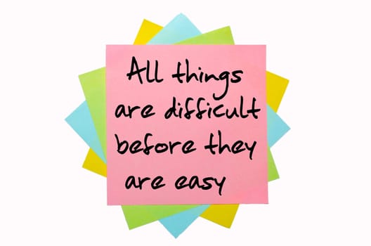 text "All things are difficult before they are easy"" written by hand font on bunch of colored sticky notes"