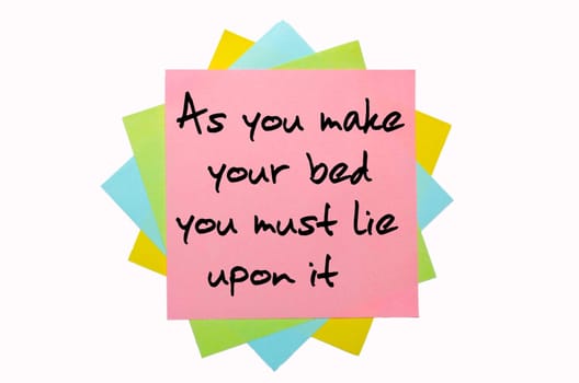 text "As you make your bed you must lie upon it"" written by hand font on bunch of colored sticky notes"