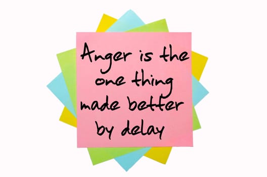 text "Anger is the one thing made better by delay"" written by hand font on bunch of colored sticky notes"