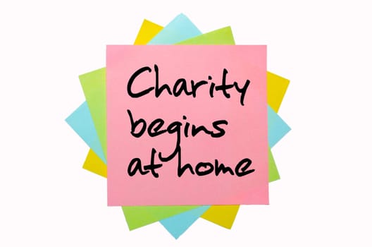 text "Charity begins at home"" written by hand font on bunch of colored sticky notes"