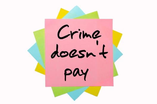 text "Crime doesn&#039 t pay"" written by hand font on bunch of colored sticky notes"