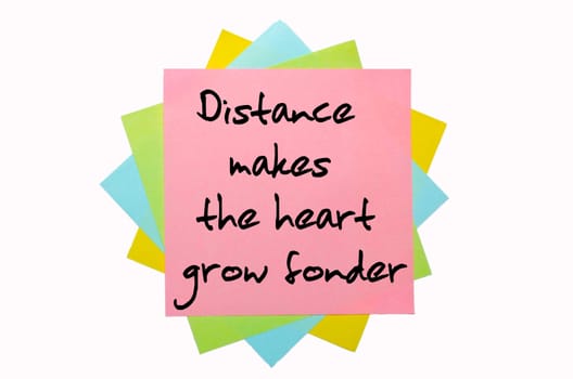 text " Distance makes the heart grow fonder"" written by hand font on bunch of colored sticky notes"