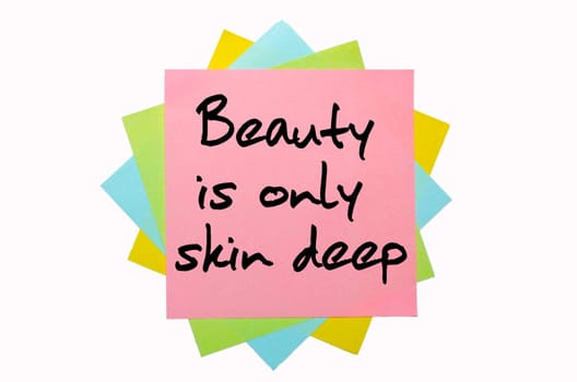 text "Beauty is only skin deep"" written by hand font on bunch of colored sticky notes"