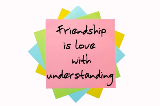 text "  Friendship is love with understanding "" written by hand font on bunch of colored sticky notes"