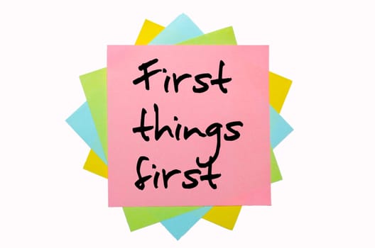text "  First things first "" written by hand font on bunch of colored sticky notes"