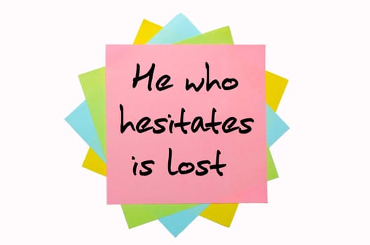 text "  He who hesitates is lost "" written by hand font on bunch of colored sticky notes"