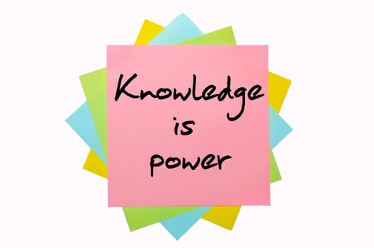 text " Knowledge is power "" written by hand font on bunch of colored sticky notes"