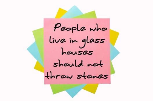 text "People who live in glass houses should not throw stones"" written by hand font on bunch of colored sticky notes"
