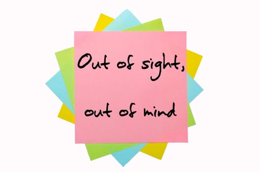 text " Out of sight, out of mind "" written by hand font on bunch of colored sticky notes"