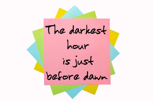 text " The darkest hour is just before dawn "" written by hand font on bunch of colored sticky notes"
