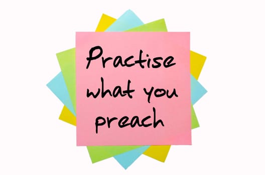 text " Practise what you preach "" written by hand font on bunch of colored sticky notes"