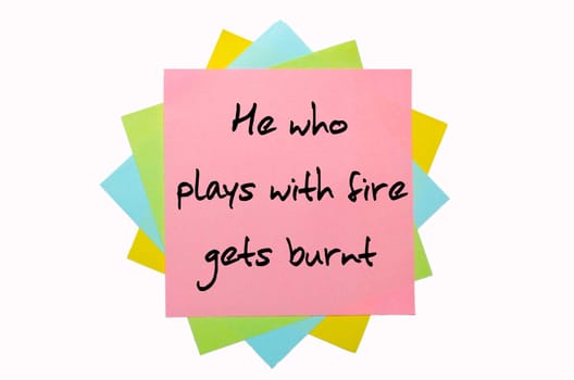 text "  He who plays with fire gets burnt "" written by hand font on bunch of colored sticky notes"