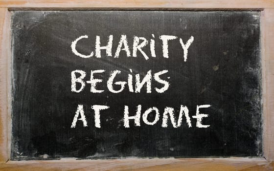 Blackboard writings "Charity begins at home"""