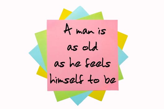 text "A man is as old as he feels himself to be"" written by hand font on bunch of colored sticky notes"