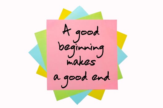 text "A good beginning makes a good end"" written by hand font on bunch of colored sticky notes"