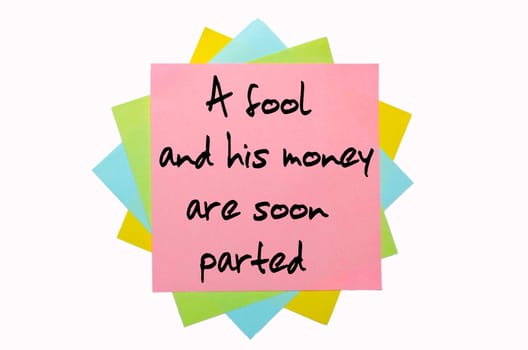text "A fool and his money are soon (easily) parted"" written by hand font on bunch of colored sticky notes"