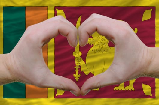 Gesture made by hands showing symbol of heart and love over srilanka