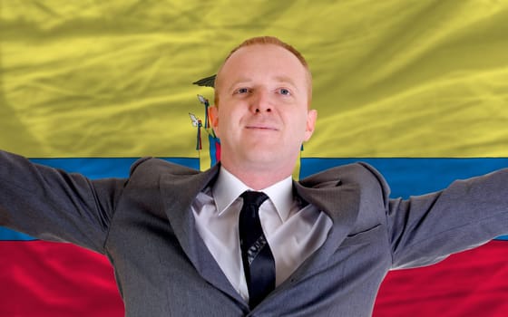 joyful investor spreading arms after good business investment in ecuador, in front of flag